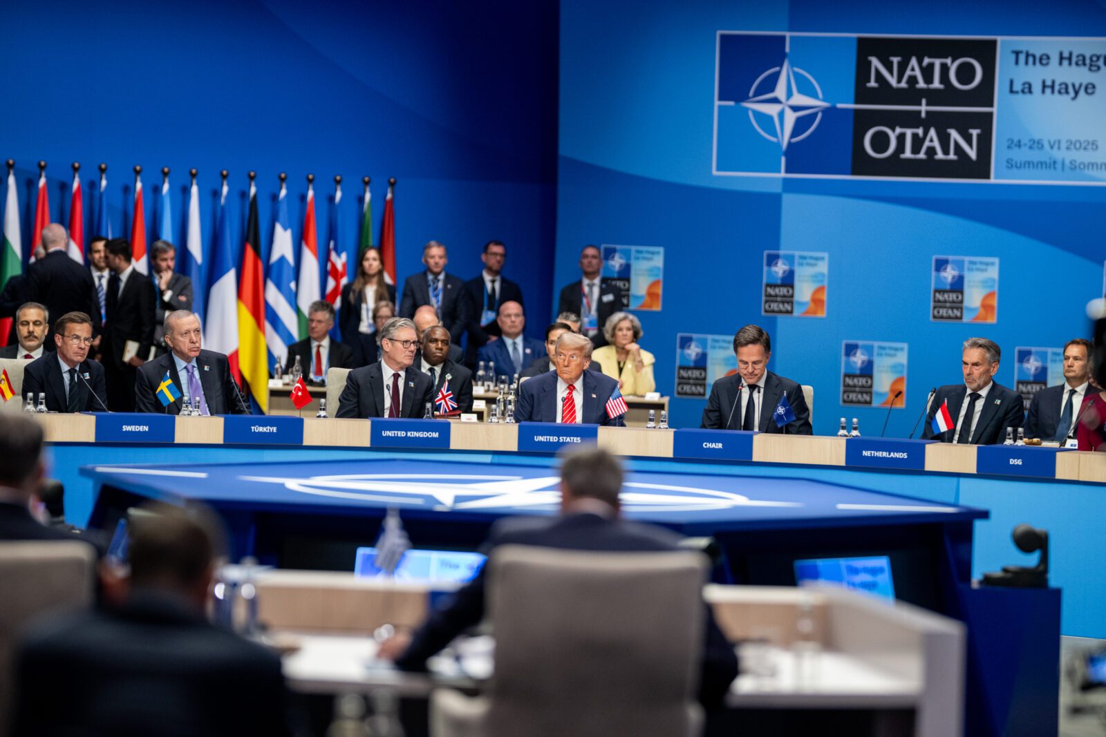 President Donald Trump sits among European leaders in a North Atlantic Council Plenary Session.