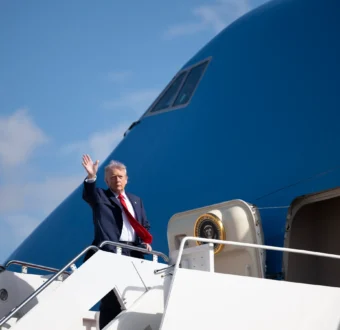 Trump waves from the stairs of Air Force One.