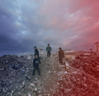 Palestinian children stand among the wreckage of a building in Gaza.